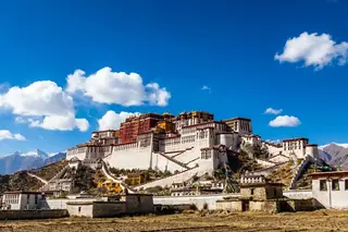 Lhasa, China — the white-and-red Potala Palace rising on Red Mountain under a deep-blue Tibetan sky