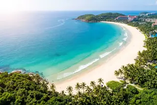 Sanya, China — aerial view of Yalong Bay's crescent white-sand beach and turquoise tropical sea