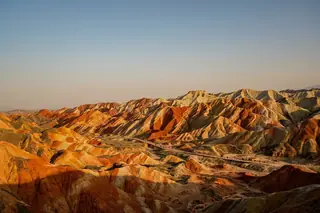 Zhangye, China — the vividly striped rainbow-colored hills of the Zhangye Danxia landform at golden hour